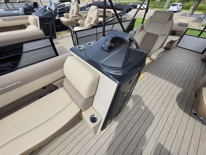 Slide: The Image of 2025 Veranda VR22RC Tri-Toon boat interior with beige seating and modern console. - 35