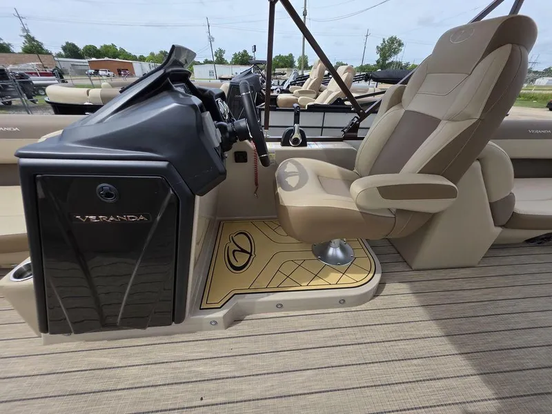 Slide: The Image of 2025 Veranda VR22RC Tri-Toon boat interior with captain's chair and steering console. - 41