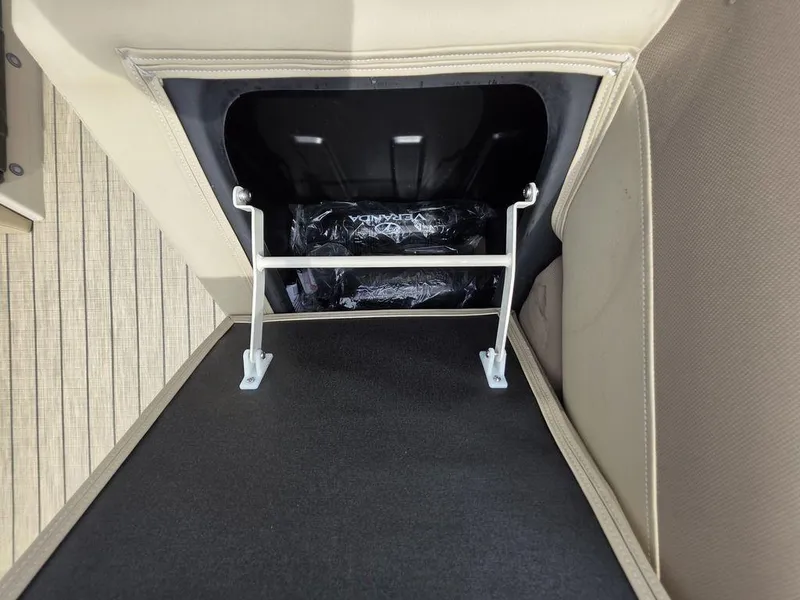 Slide: The Image of Open storage compartment in 2025 Veranda VR22RC Tri-Toon boat, featuring beige upholstery. - 43