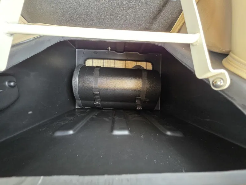 Slide: The Image of 2025 Veranda VR22RC Tri-Toon storage compartment with secured black cylinder. - 46