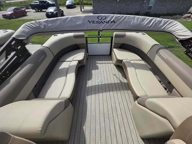 Slide: The Image of 2025 Veranda VR22RC Tri-Toon boat interior with beige seating and spacious layout. - 6