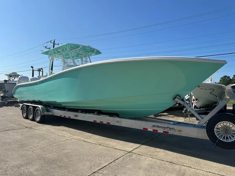 Slide: The Image of 2024 Yellowfin 36 Offshore boat on trailer, light blue hull, sunny day. - 0