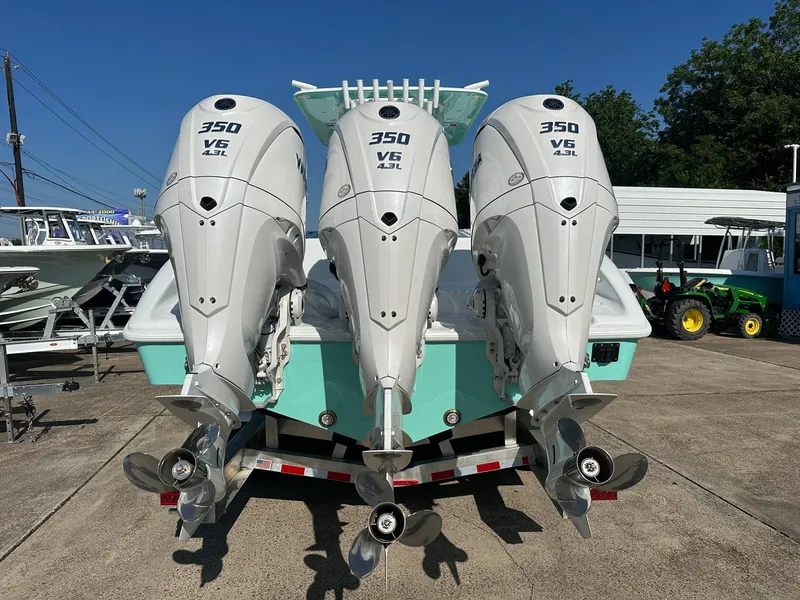 Slide: The Image of 2024 Yellowfin 36 Offshore boat with triple 350 V6 engines, displayed outdoors. - 11