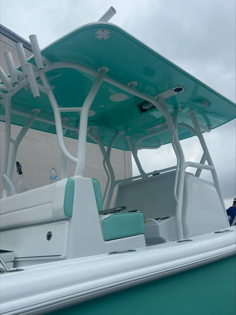 Slide: The Image of 2024 Yellowfin 36 Offshore boat with teal accents and sturdy T-top design. - 6