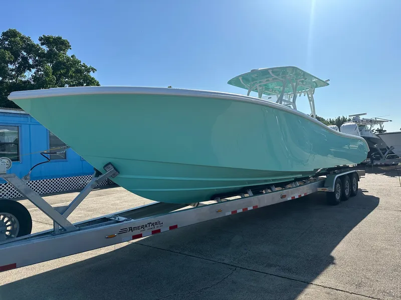 Slide: The Image of 2024 Yellowfin 36 Offshore boat on trailer, mint green hull, sunny day. - 8