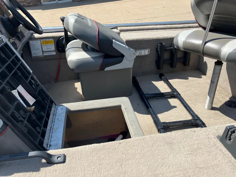 Slide: The Image of 2007 Tracker Pro Crappie 175 boat interior with open storage compartment and seating. - 11