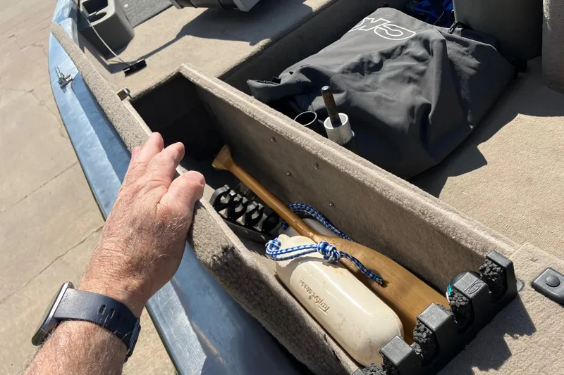 Slide: The Image of 2007 Tracker Pro Crappie 175 boat storage with paddle and gear. - 21