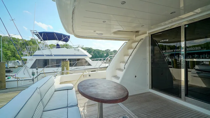 Slide: The Image of Luxury yacht deck with seating, table, and stairs; Viking Princess 68, 2002 model. - 10
