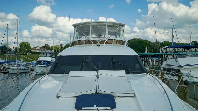 Slide: The Image of Luxury Viking Princess 68 yacht docked at marina, 2002 model, under a partly cloudy sky. - 14