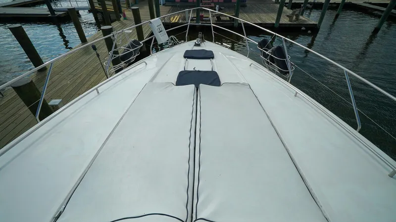 Slide: The Image of Bow view of 2002 Viking Princess 68 yacht docked at marina. - 17