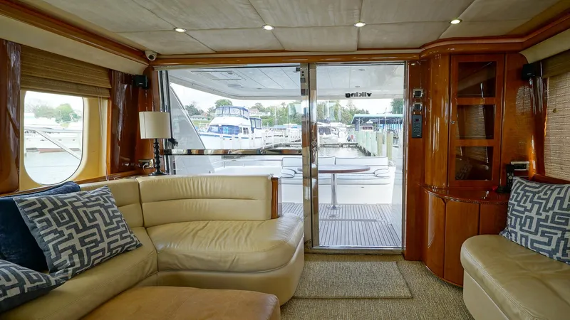 Slide: The Image of Luxurious 2002 Viking Princess 68 yacht interior with plush seating and marina view. - 21