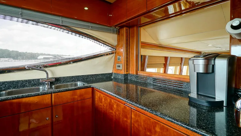 Slide: The Image of Luxurious kitchen interior of 2002 Viking Princess 68 yacht with sleek countertops and modern appliances. - 24
