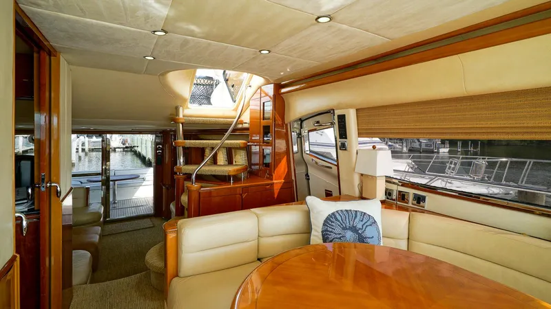 Slide: The Image of Luxurious interior of a 2002 Viking Princess 68 yacht with elegant seating and wooden finishes. - 27