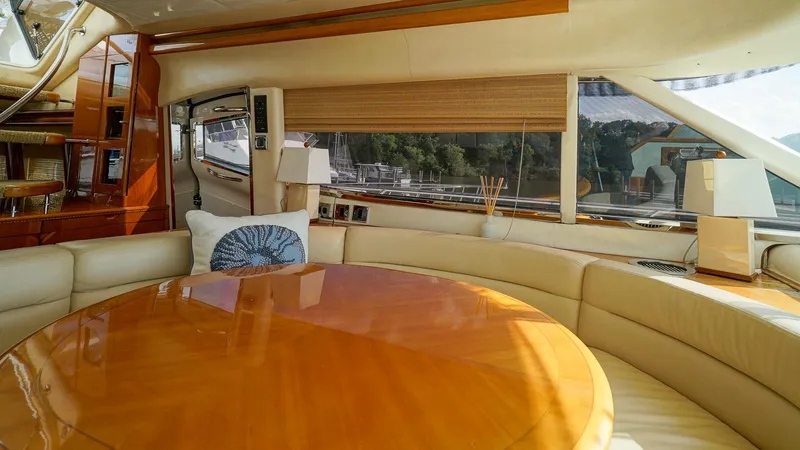 Slide: The Image of Luxurious interior of 2002 Viking Princess 68 yacht with elegant wood table and plush seating. - 28