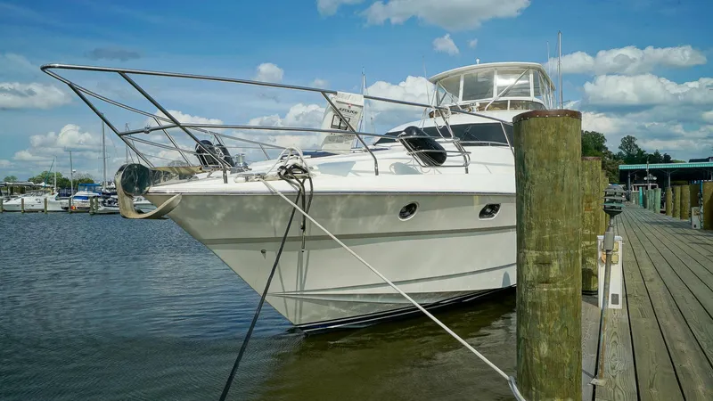 Slide: The Image of Luxury 2002 Viking Princess 68 yacht docked at marina under blue sky. - 3