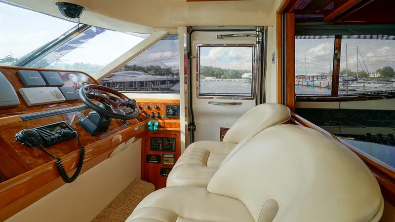 Slide: The Image of Luxurious 2002 Viking Princess 68 yacht interior with leather seating and wooden helm. - 30