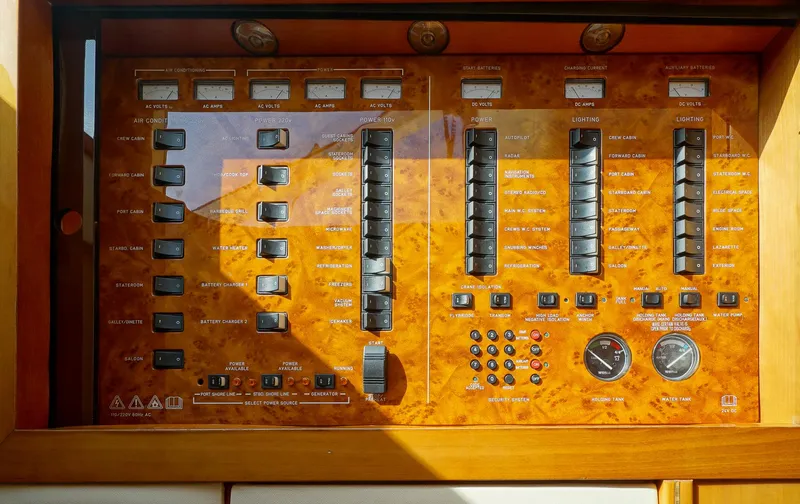 Slide: The Image of Control panel of a 2002 Viking Princess 68 yacht with switches and gauges. - 31