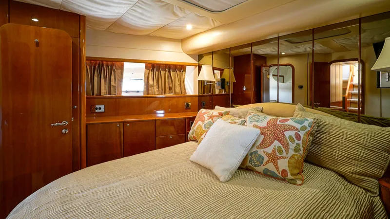 Slide: The Image of Luxurious bedroom interior of 2002 Viking Princess 68 yacht with elegant wood finishes. - 34