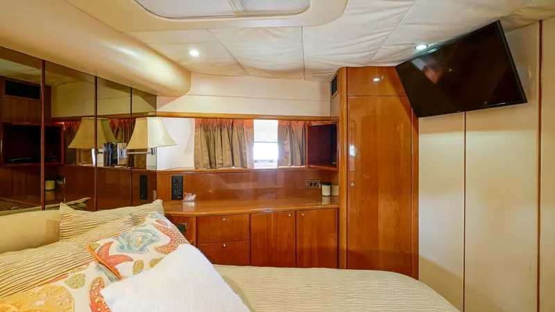 Slide: The Image of Luxurious cabin interior of 2002 Viking Princess 68 yacht with wood finishes and modern amenities. - 35