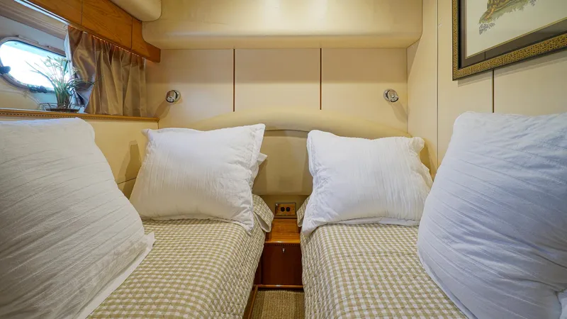 Slide: The Image of Twin beds in a cozy cabin of a 2002 Viking Princess 68 yacht. - 39