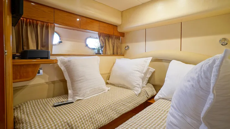 Slide: The Image of Cozy twin cabin in 2002 Viking Princess 68 yacht with plush pillows and elegant decor. - 40
