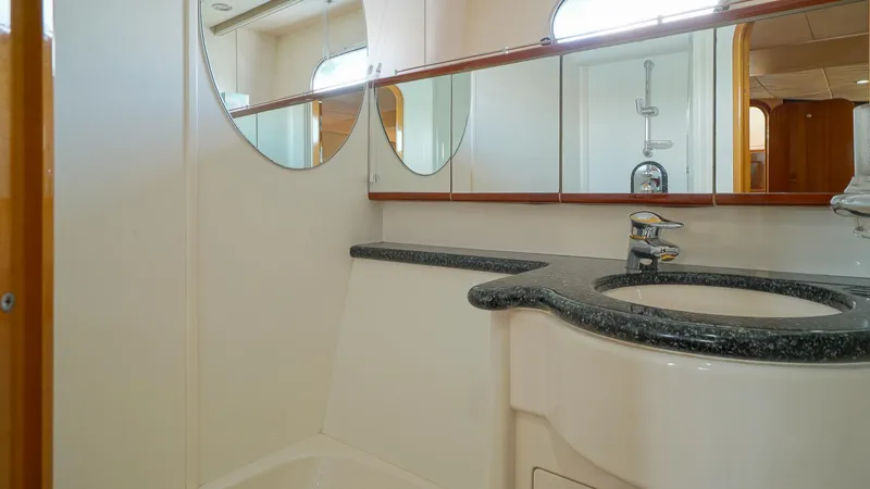 Slide: The Image of Luxurious bathroom in 2002 Viking Princess 68 yacht with elegant fixtures and mirrors. - 46