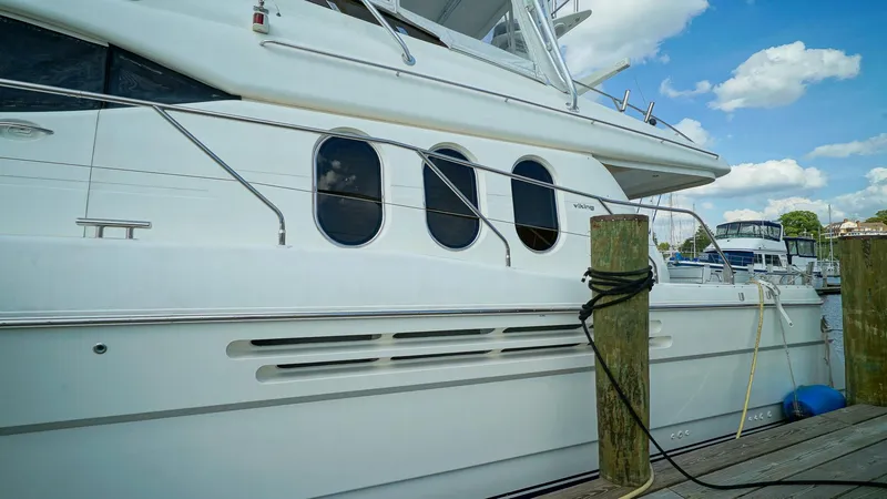 Slide: The Image of Luxury yacht Viking Princess 68, 2002 model, docked at marina under blue sky. - 5