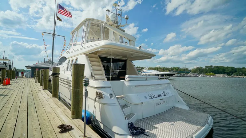 Slide: The Image of Luxury yacht Viking Princess 68, 2002 model, docked at marina under blue sky. - 6