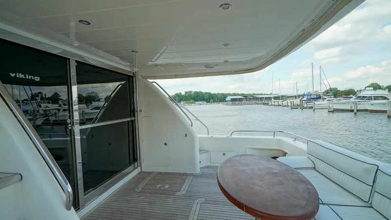 Slide: The Image of Spacious deck of 2002 Viking Princess 68 yacht with marina view. - 9