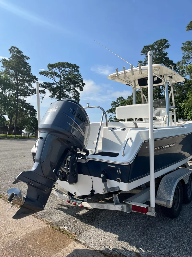 Slide: The Image of 2011 Sea Hunt Ultra 232 boat on trailer, featuring a powerful outboard motor. - 15