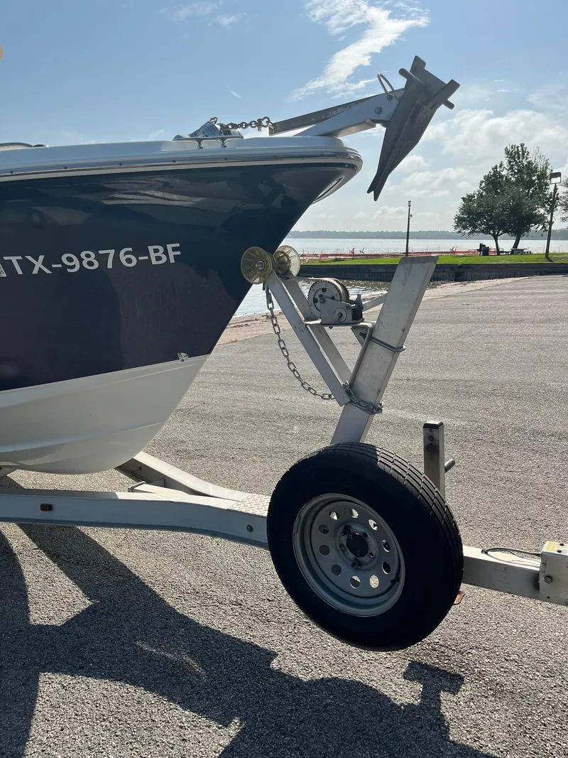 Slide: The Image of 2011 Sea Hunt Ultra 232 boat on trailer, parked near waterfront. - 19