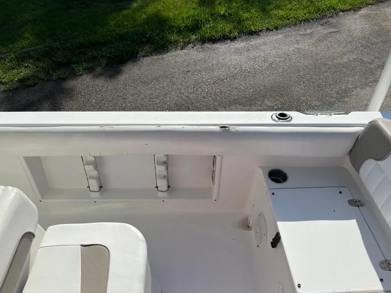 Slide: The Image of 2011 Sea Hunt Ultra 232 boat interior with seating and storage compartments. - 24