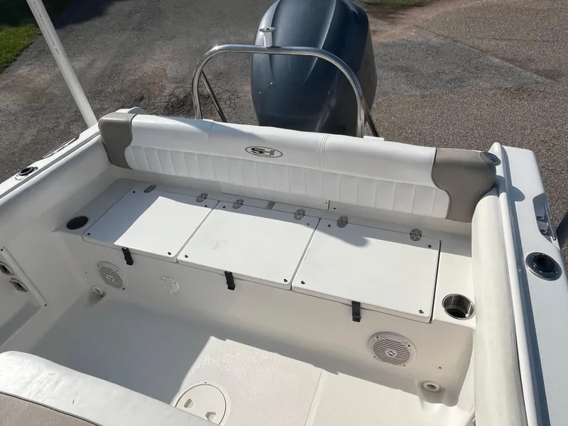 Slide: The Image of 2011 Sea Hunt Ultra 232 boat interior with seating and storage compartments. - 25