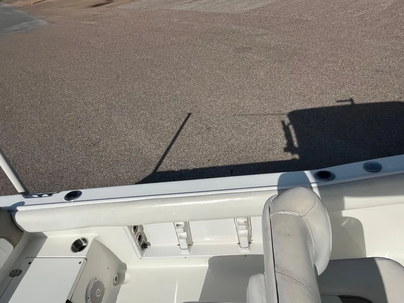 Slide: The Image of 2011 Sea Hunt Ultra 232 boat interior with seating and rod holders. - 26