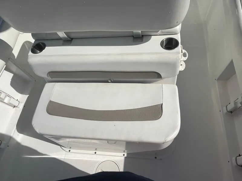 Slide: The Image of 2011 Sea Hunt Ultra 232 boat seating with cup holders, white upholstery. - 27