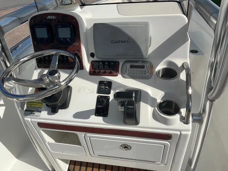 Slide: The Image of 2011 Sea Hunt Ultra 232 boat console with Garmin GPS, steering wheel, and controls. - 29