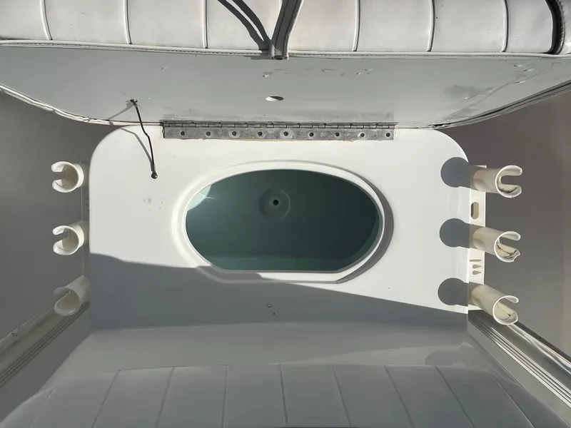 Slide: The Image of 2011 Sea Hunt Ultra 232 boat interior with rod holders and storage compartment. - 36