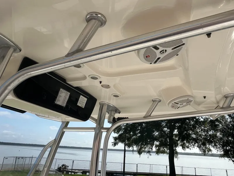 Slide: The Image of 2011 Sea Hunt Ultra 232 boat interior with speakers and metal framework, overlooking a serene lake. - 39
