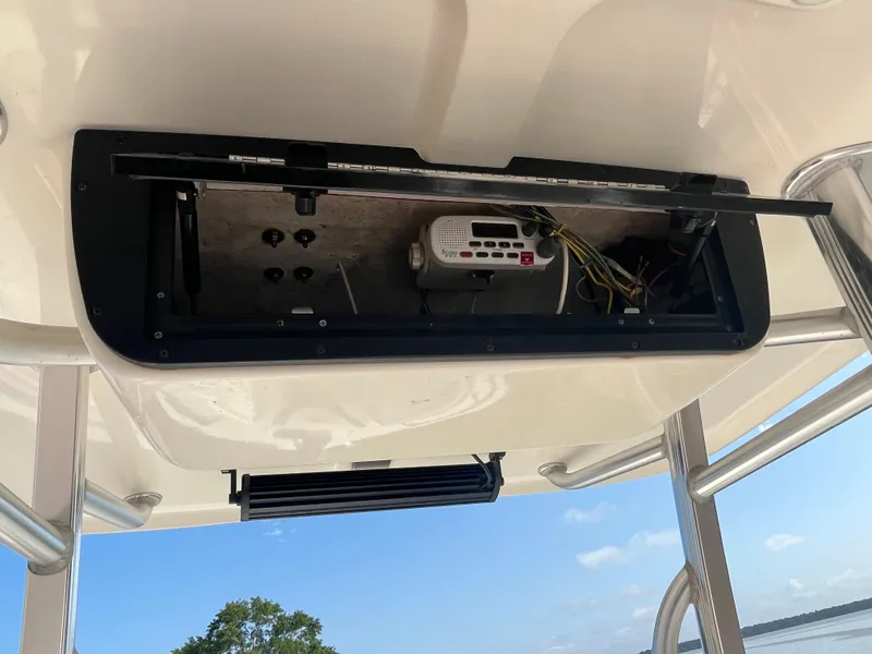 Slide: The Image of 2011 Sea Hunt Ultra 232 boat electronics compartment with radio and wiring. - 40