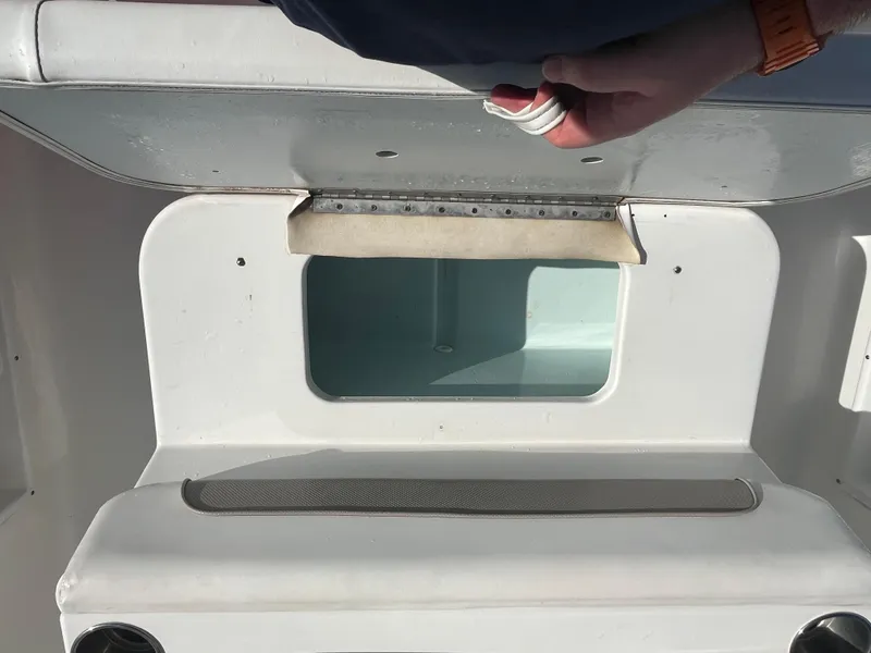Slide: The Image of 2011 Sea Hunt Ultra 232 boat compartment with open hatch and visible interior. - 41