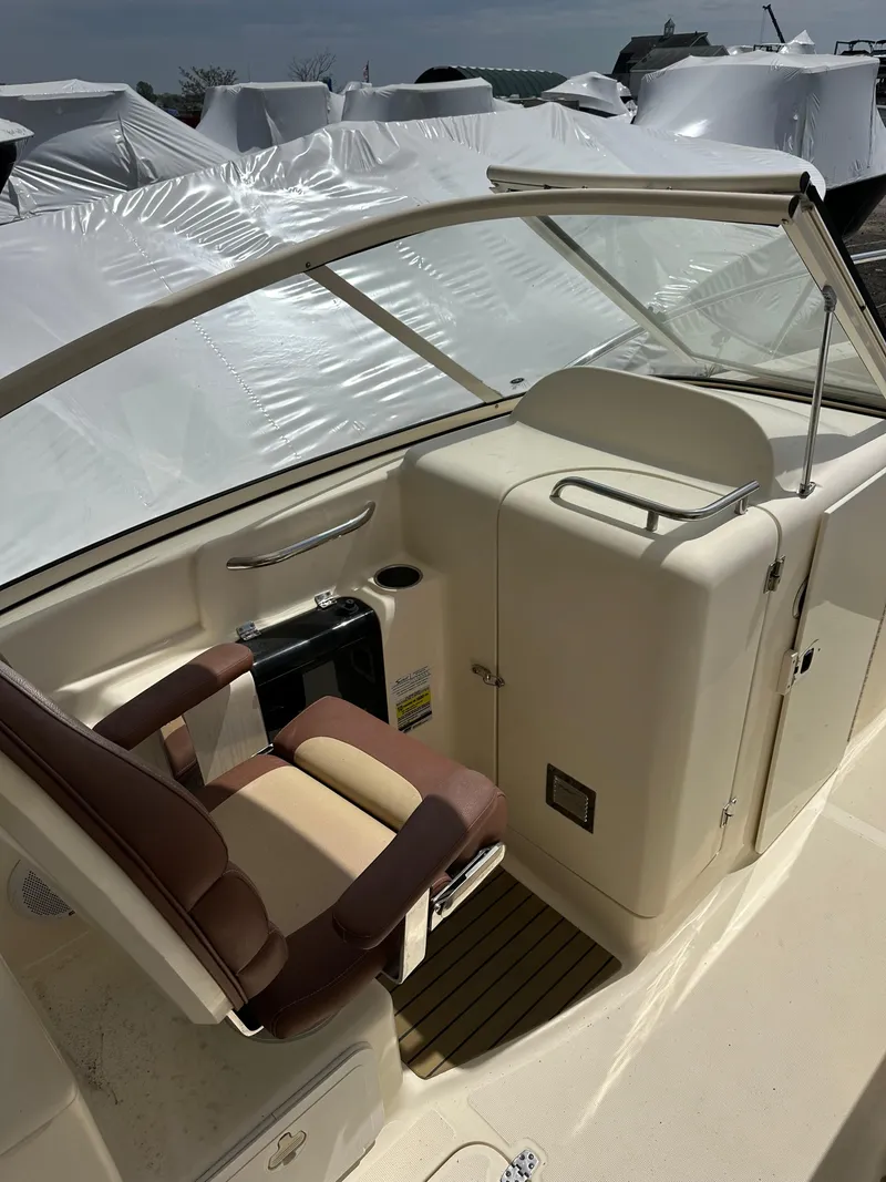 Slide: The Image of 2014 Scout 245 Dorado boat interior with seating and console. - 10