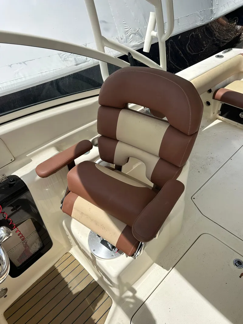 Slide: The Image of Brown and beige captain's chair on 2014 Scout 245 Dorado boat. - 12