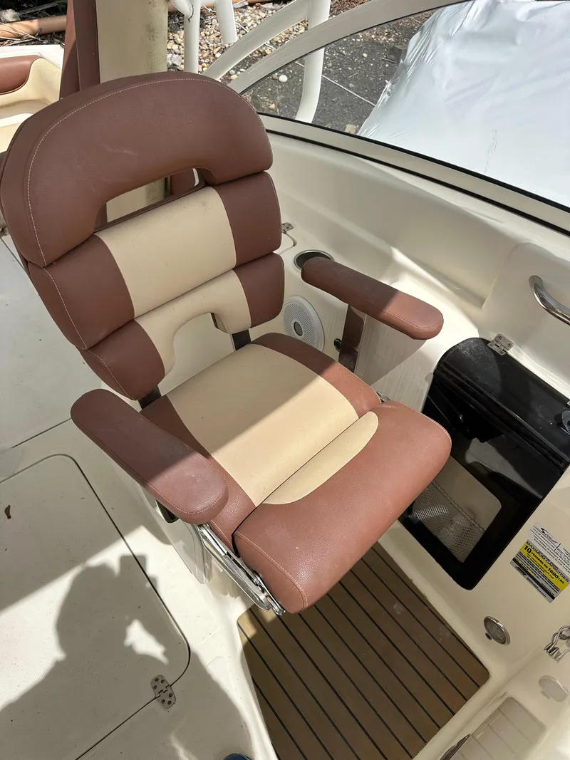 Slide: The Image of Brown and beige captain's chair on 2014 Scout 245 Dorado boat. - 13