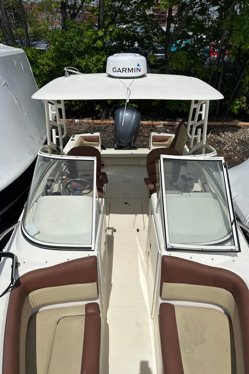 Slide: The Image of 2014 Scout 245 Dorado boat with Garmin equipment, featuring open seating and dual consoles. - 15