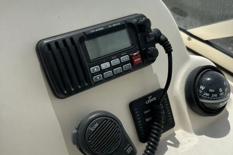 Slide: The Image of 2014 Scout 245 Dorado boat dashboard with radio and compass. - 21