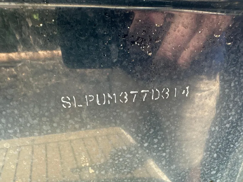 Slide: The Image of VIN on 2014 Scout 245 Dorado boat, displaying "SLPUN377D314" on a weathered surface. - 23