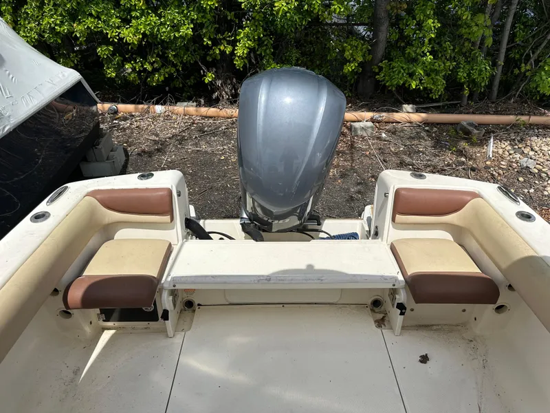 Slide: The Image of 2014 Scout 245 Dorado boat interior with outboard motor and seating. - 9