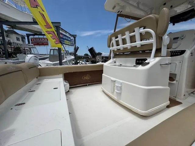 Slide: The Image of 2020 NauticStar 2602 Legacy boat interior with seating and fishing rod holders. - 13