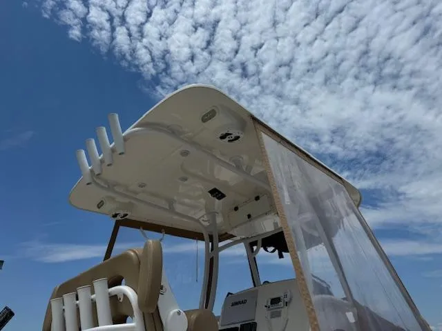 Slide: The Image of 2020 NauticStar 2602 Legacy boat with T-top under a cloudy sky. - 15