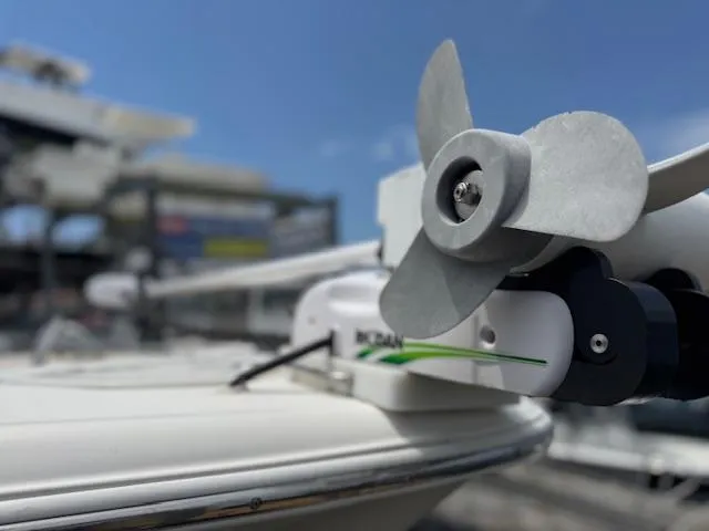 Slide: The Image of 2020 NauticStar 2602 Legacy boat with close-up of propeller against a clear sky. - 3
